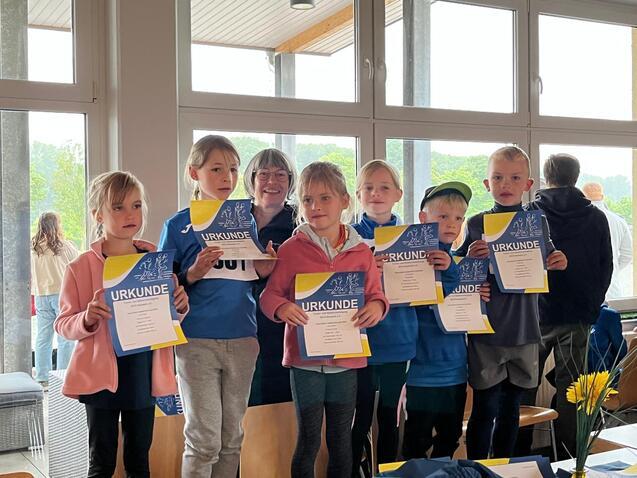 Kinder zeigen ihre Urkunden