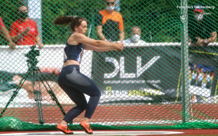 Sportlerin mit Hammer im Wurfk&auml;fig